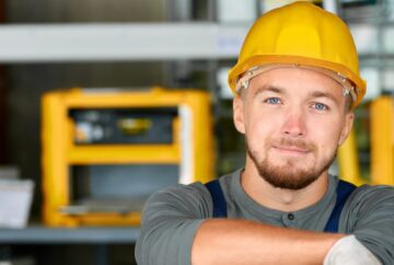 Field service engineer with blue eyes and yellow hard hat