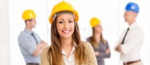 Female field service engineer in yellow hard hat working for